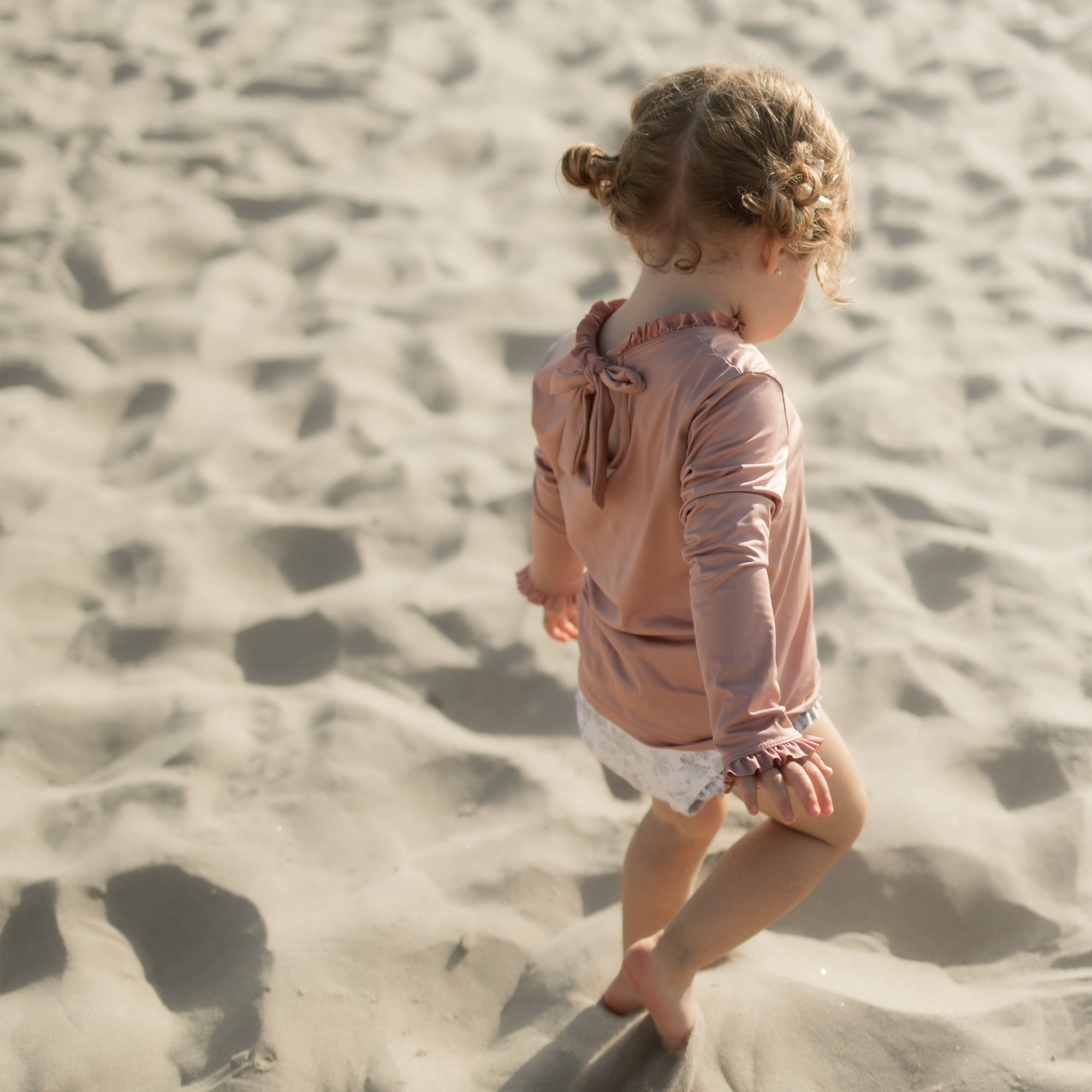 Child walking on a sandy beach